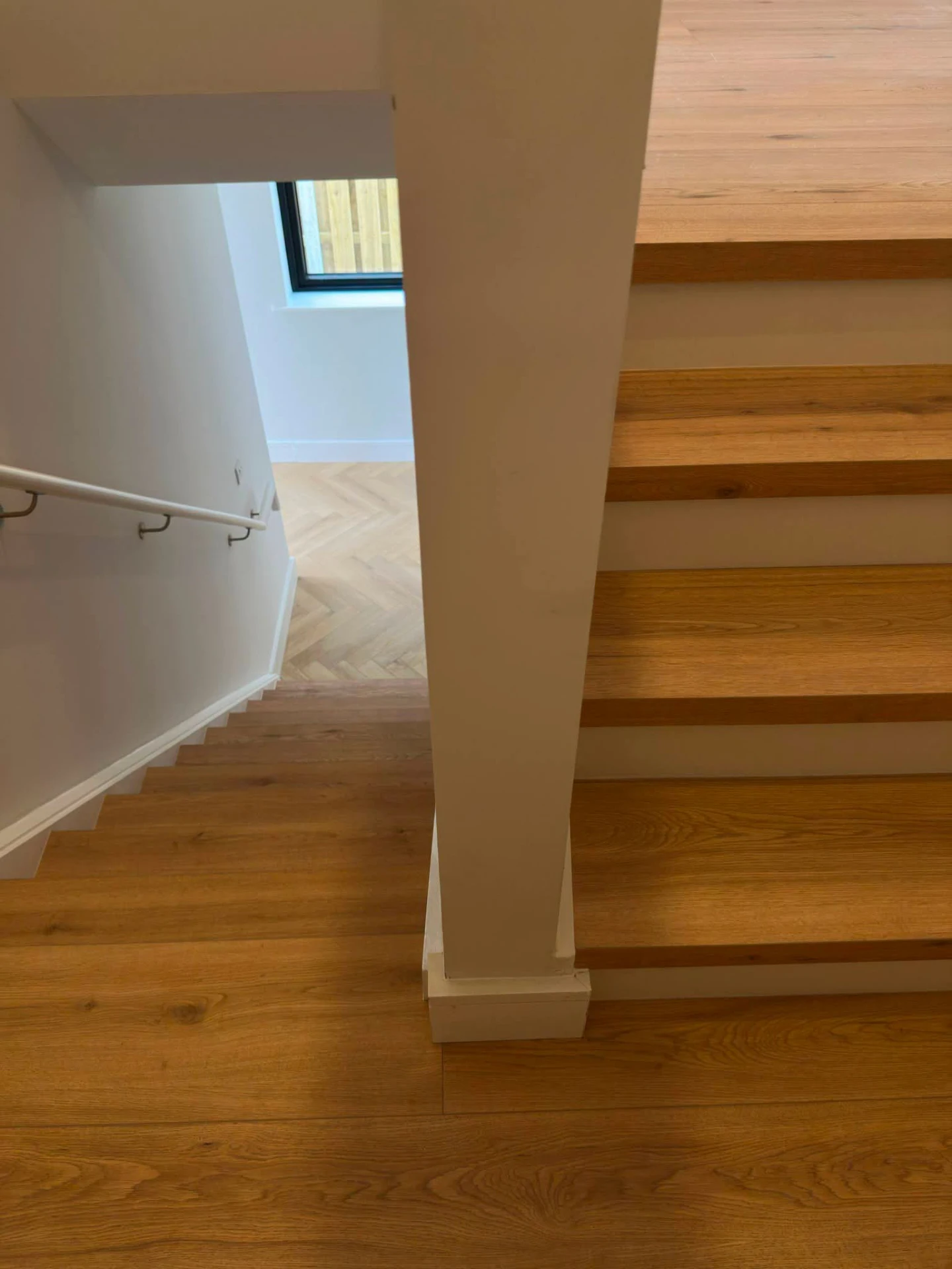 Natural oak stair treads with white risers viewed from the landing
