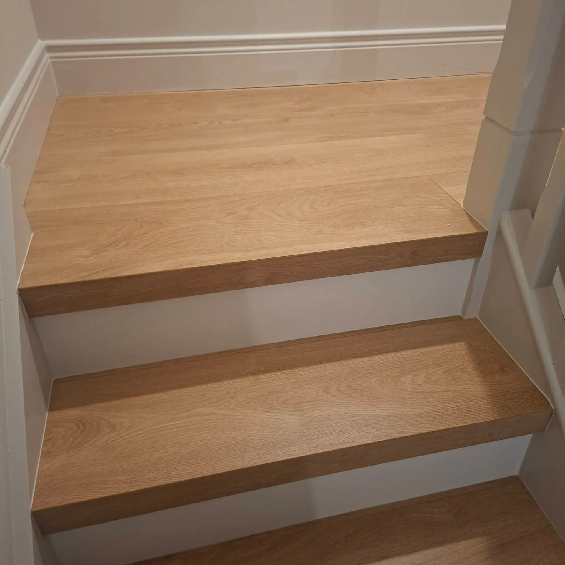 Close-up of oak stair treads with square nosing and white risers